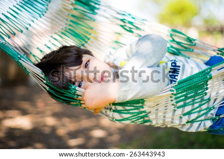 Similar – Der kleine Junge und die Mutter sitzen an der Hängematte.