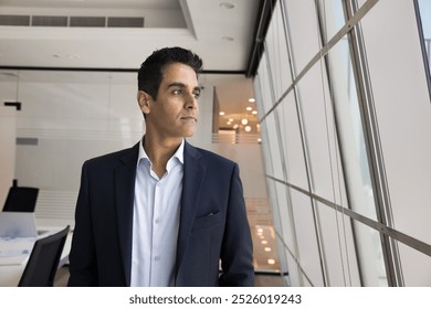 Thoughtful company director man in formal jacket posing in office, looking at window away in deep thoughts, thinking on future project, marketing solutions, business ambition. Portrait with copy space - Powered by Shutterstock