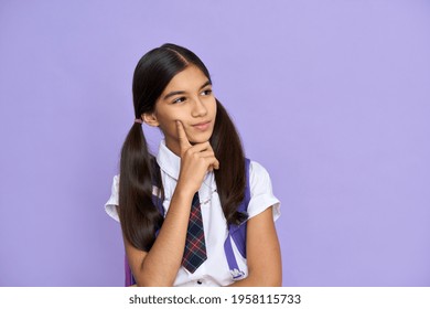 Thoughtful Deciding Indian Schoolgirl, Preteen Kid Thinking Looking At Copy Space Having Question, Making Choice. Latin Junior Student Advertising Standing Isolated On Violet Lilac Background