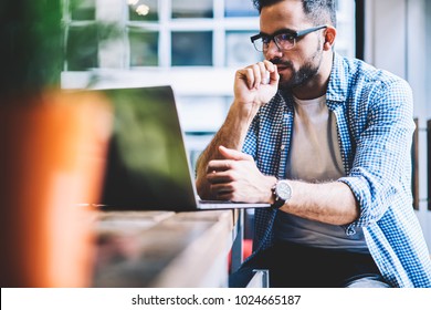 Thoughtful It Developer Thinking About Fixing Software Bugs On Netbook Downloading Files From Network,contemplative Male Student Watching Tutorial On Web Site Learning Online Via Laptop Computer