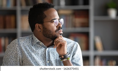 Thoughtful Doubtful African American Businessman Wear Glasses Looking Away Thinking Of Problem Solution Future Challenges, Serious Ethnic Man Profile Face Feel Uncertain Lost In Thoughts Concept