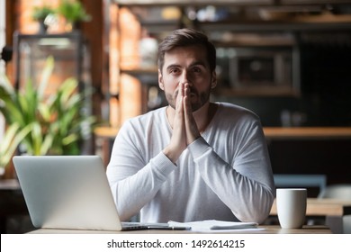 Thoughtful doubtful businessman in tension thinking make difficult decision at work, stressed man put hands in prayer pray with hope pondering reflecting concerned about problem challenge sit at desk - Shutterstock ID 1492614215