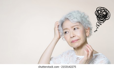 Thoughtful elderly Asian woman. Beauty concept. Anti aging. Aging care. Skin care. Cosmetics. - Powered by Shutterstock