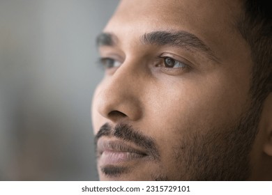 Thoughtful handsome young Indian man facial close up portrait. Face of pensive serious attractive guy with stylish stubble, beard, looking away, thinking, dreaming - Powered by Shutterstock