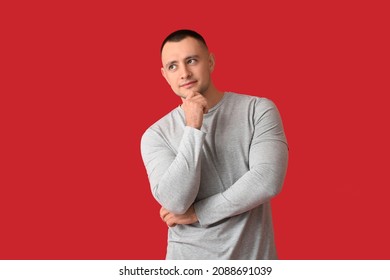 Thoughtful Handsome Young Man On Color Background