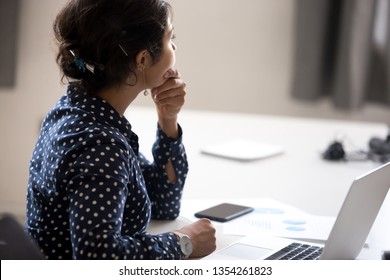 Thoughtful Indian Businesswoman Looking In Distance At Workplace, Doubting, Female Employee Thinking Of Difficult Question, Task, Received News, Tired Office Worker Have Too Much Work, Rear View