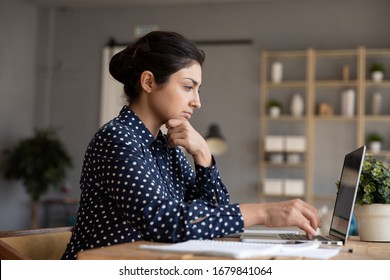 Thoughtful Indian Woman Looking At Laptop Screen, Pondering Task, Businesswoman Freelancer Working On Difficult Project, Pensive Female Student Preparing To Exam Or Test, Doing Homework