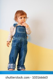 Thoughtful Kid Standing On The Furniture