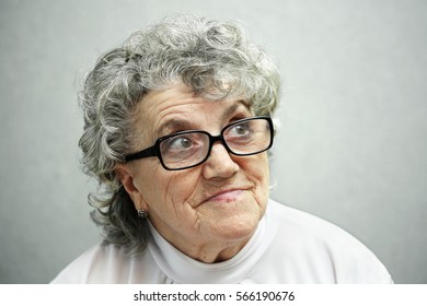 Thoughtful and looking grandmother in glasses