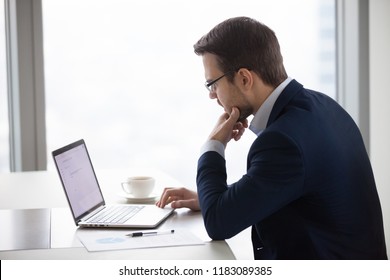 Thoughtful Male CEO Looking At Laptop Screen Making Decision Or Writing Business Email, Serious Businessman Thinking About Contract Or Deal Terms, Man Busy Analyzing Statistics Preparing Report