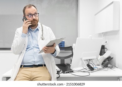 Thoughtful Male Doctor Using Digital Tablet Thinking Of Medical Problem Solution. High Quality Photography