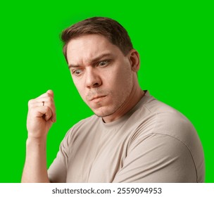 Thoughtful man gestures against a green background - Powered by Shutterstock