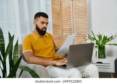 A thoughtful man reviews documents while sitting comfortably at home. - Powered by Shutterstock