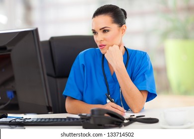 Thoughtful Medical Doctor Looking At Computer Screen In Office