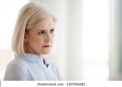 Thoughtful Middle-aged Female Worker Look In Distance Thinking Of Problem Solution, Making Plans, Concentrated Mature Businesswoman Focused Considering Or Pondering. Business Vision Concept