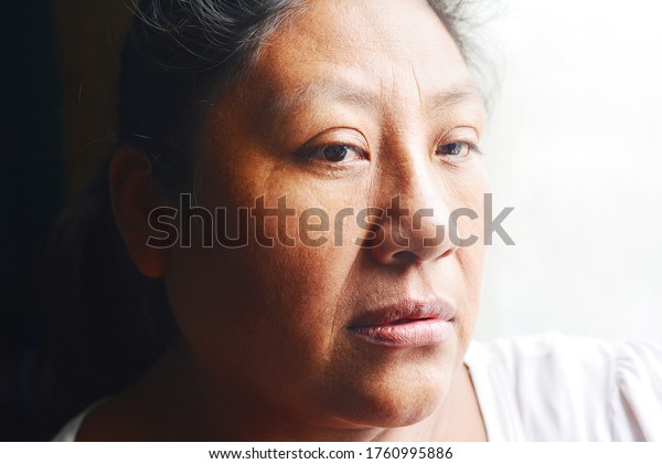 Thoughtful native\
american woman in her\
50s.