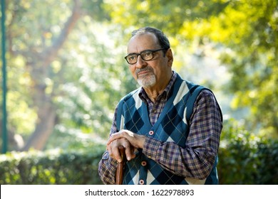 Thoughtful Old Man Sitting On Park Alone