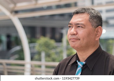 Thoughtful Old Man Thinking, Senior Man Planning With Idea; Portrait Of Stressed, Serious Asian Man Thinking, Planning, Finding A Good Idea; South East Or Southeast Asian 50s  Old Senior Man Model