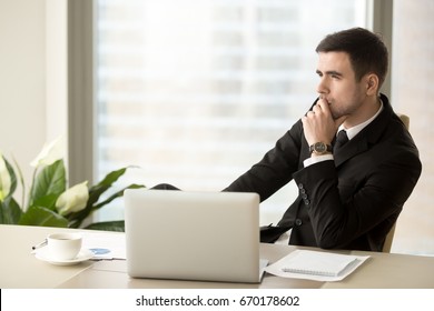 Thoughtful pensive businessman deep in thoughts looking away sitting near laptop at workplace, successful entrepreneur thinking over new ways to improve business, future perspectives, managing risks  - Powered by Shutterstock