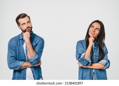 Thoughtful pensive caucasian young couple looking upwards for free space copyspace, thinking new ideas, planning for future together isolated in white background - Powered by Shutterstock