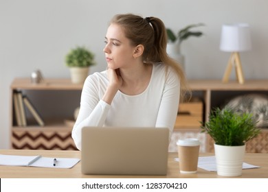 Thoughtful pensive female student looking away thinking of problem solution, serious young woman searching inspiration new ideas working on laptop lost in thought, creativity crisis, writers block