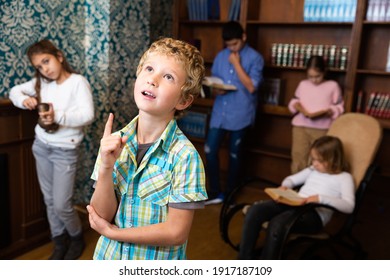 Thoughtful Preteen Boy Thinking About Solving Puzzle To Get Out Of Closed Space Of Escape Room