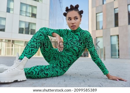 Similar – Woman with green boots walking on spinach field.