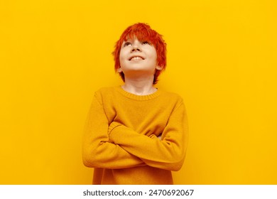 thoughtful red-haired teenage boy planning and thinking over yellow isolated background, cheerful child with orange hairstyle dreaming and imagining - Powered by Shutterstock