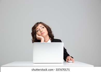 Thoughtful Sad Depressed Curly Pretty Business Woman Dreaming Sitting At The Laptop