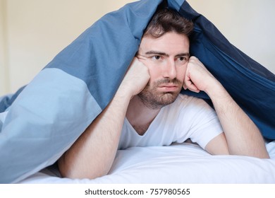 Thoughtful And Sad Man Face Expression Lying In The Bed