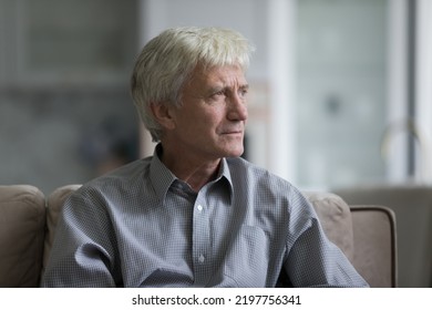 Thoughtful sad senior elder man sitting on home couch, looking away, thinking over health problems, feeling depressed, lonely, frustrated, coping with loss, grief, disease, mental disorder - Shutterstock ID 2197756341