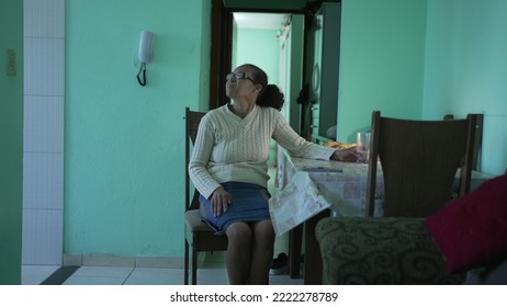 A Thoughtful Senior Black Woman Sitting A Home Alone. A Pensive Hispanic South American Elderly Person In Living Room