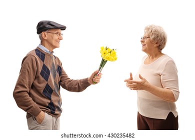 Thoughtful Senior Man Giving Flowers To A Joyful Senior Lady Isolated On White Background