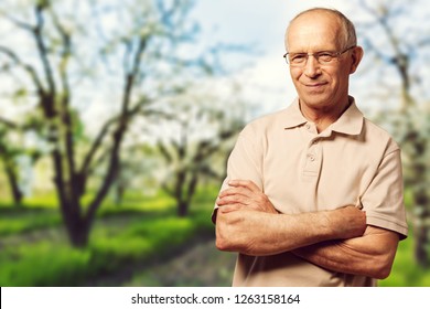 Thoughtful Senior Man With Glasses Outdoors