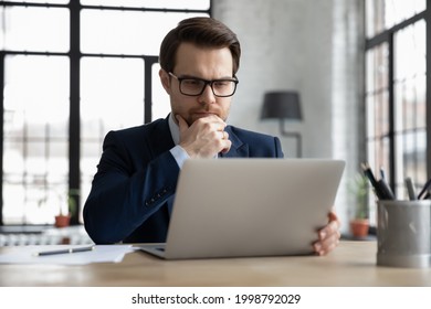 Thoughtful serious businessman reading email message on laptop screen, thinking over problem solving and making decision, watching online video conference or learning webinar, analyzing market - Powered by Shutterstock