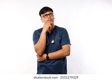 Thoughtful smart asian male nurse in scrubs looking away and thinking,curious and confused gesture. Doctor have interesting idea, pondering over white background - Powered by Shutterstock