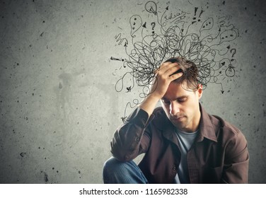 Thoughtful stressed young man with a mess - Shutterstock ID 1165982338