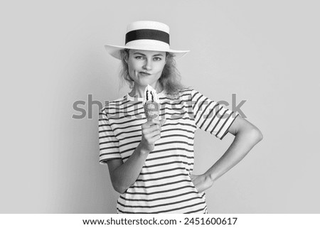 thoughtful summer woman with sweet cone in retro hat. summer woman with sweet cone isolated on yellow. summer woman with sweet cone in studio. summer woman with sweet cone on background