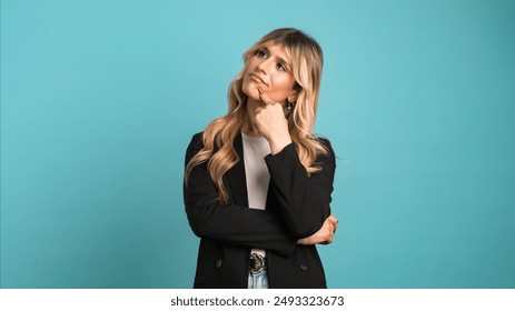 Thoughtful transgender businesswoman thinking of an idea against blue background - Powered by Shutterstock