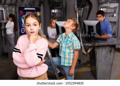 Thoughtful Tween Girl Thinking About Solving Puzzle To Get Out Of Closed Space Of Escape Room Designed As Abandoned Bunker