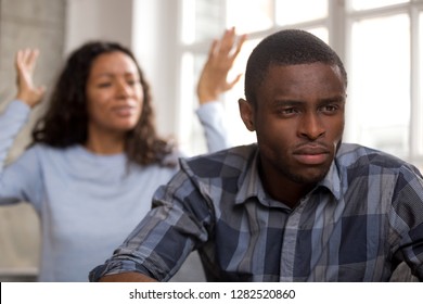 Thoughtful Upset African Husband Feels Disappointed In Love Ignoring Avoiding Angry Wife Shouting Blaming Spouse, Sad Pensive Black Man Frustrated About Couple Fight Quarrel And Bad Relationships