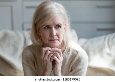 Thoughtful Upset Mature Old Lady Feeling Blue Thinking Of Loneliness Or Grief, Sad Middle Aged Woman Worried Concerned About Problems, Serious Depressed Senior Female Widow Crying Grieving Mourning