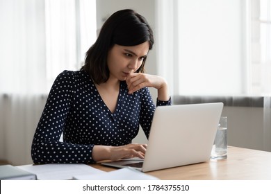 Thoughtful Vietnamese millennial girl sit at desk at home study online on laptop pondering of problem solution, pensive Asian young woman work with document on computer thinking contemplating - Shutterstock ID 1784375510