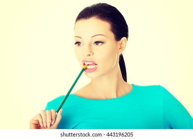 Thoughtful Woman Biting Pencil