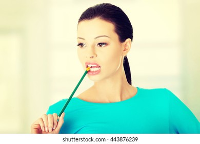 Thoughtful Woman Biting Pencil