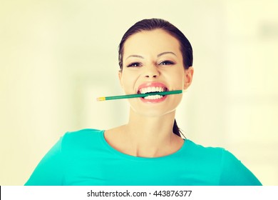 Thoughtful Woman Biting Pencil