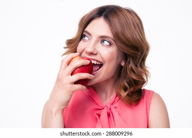 Thoughtful woman eating apple isolated on a white background. Looking away