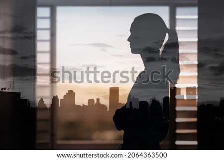 thoughtful woman looking window at the city view. Vision and future concept. 