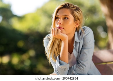 Thoughtful Woman Sitting Alone Outdoors