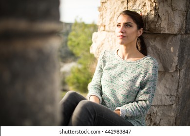 Thoughtful Woman Sitting Alone Outdoors.Daydreaming And Imagining.Overcoming Depression And Anxiety Problems.Optimistic Person Expression.Reflecting On Past.Relaxing Walk In Nature.Stress Relief